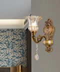 Matte Brass Vintage Wall Mount Lamp With Beveled Crystal Shade, Antique Floral Sconce Light With Retro Vibes on gray wall