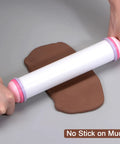 Silicone Rolling Pin For Baking 20.5 Inch Nonstick Kitchen Roller with rubber handles rolling brown dough.