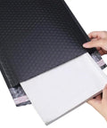 Five Pack Black Waterproof Bubble Mailers With Tear And Shake Resistant Envelope Bags For Shipping Jewelry Glass Art Photos And More Durable Protective Packaging For Mailing Supplies being opened by hands
