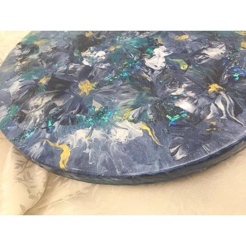 Close-up of 16 inch floral resin Lazy Susan in blue gold white on wood serving tray base.