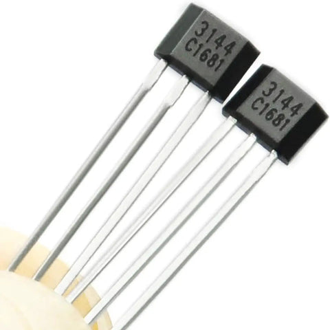Close-up of two TO92 linear Hall effect sensors, model 3144, used for EV motor repair and electronics fix.