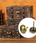 Hella Sturdy Gold Upholstery Tacks 100 Pack Set For Furniture Nailhead Decorative Trim displayed near vintage trunks.