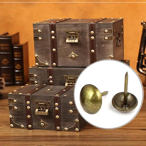 Hella Sturdy Gold Upholstery Tacks 100 Pack Set For Furniture Nailhead Decorative Trim displayed near vintage trunks.