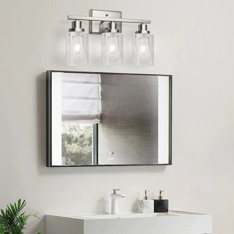 Killer 3 Light Wall Sconces With Clear Glass Shade And Brushed Nickel Finish above a modern bathroom mirror, illuminating the space.