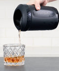 Patented Iced Coffee And Beverage Cooler That Chills In One Minute, Reusable For Iced Tea, Wine, Spirits, Juice, And More, Now Stronger, More Durable With New V2 Upgrade, 12.5 Oz, Black in use pouring chilled beverage into a glass.