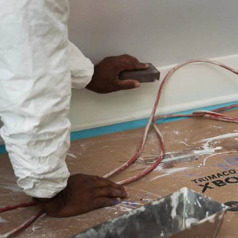 X Board Paint and Remodel Surface Protector Heavy Duty Breathable Floor Shield 35 Inch by 100 Feet Roll in use during sanding