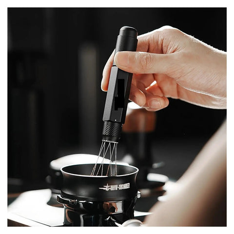 Professional Espresso Coffee Ground Distributor With 16 Stainless Steel Needles Magnetic Telescopic Stirrer in use for leveling coffee grounds.