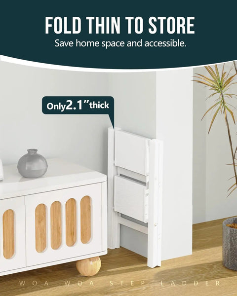 Sturdy 2 Step Ladder With 17 Inch Top Step, 300 Lb Capacity, White Finish, Wider 7.9 Inch Treads For Comfort And Stability, Great For Home, Garage, And DIY Tasks., white foldable 2-step ladder stored thin beside cabinet