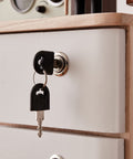 Close-up of lock and key on wooden file cabinet with four drawers for desk storage, part of durable and stylish boss level workspace saver.