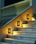 Solar Flame Lights Outdoor Waterproof LED Wall Lanterns With Flickering Flames on a stairway illuminating steps at night.