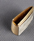 Solid Brass Habaki Collar Clip for Katana securing blade and tsuba, premium durable craft, side view on gray background.