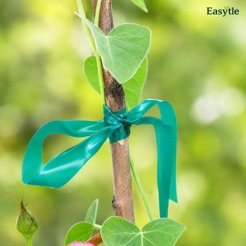 Built Tough Garden Tie Tape Roll Half Inch Wide 300 Feet Long Green Vinyl Plant Support Ribbon securing a plant stem