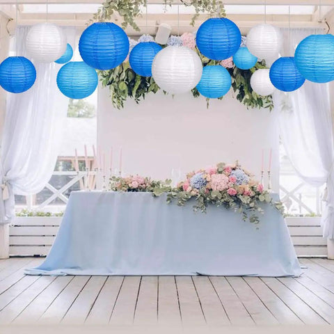 Blue And White Hanging Round Paper Lantern Set - 24 Pack Multi-Size Lanterns for Weddings shown in a decorated venue