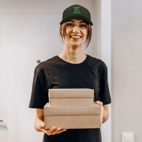 Woman holding boxes wearing Mens Army Green Trucker Cap With Adjustable Buckle Four Seasons Comfort Stylish Everyday Hat One Size