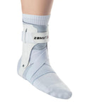 A2 DX White Ankle Brace For Sport With Breathable Comfort And Dual X Strap Stabilizers, left foot, worn by a person, large size