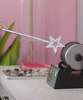 Person using a star wand with Advanced Rock Tumbler Kit With Digital Polishing Timer And Three Speed Settings on pink backdrop