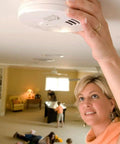 Worry Free Kitchen Photoelectric Smoke And Carbon Monoxide Alarm With 10 Year Sealed Battery being installed on ceiling