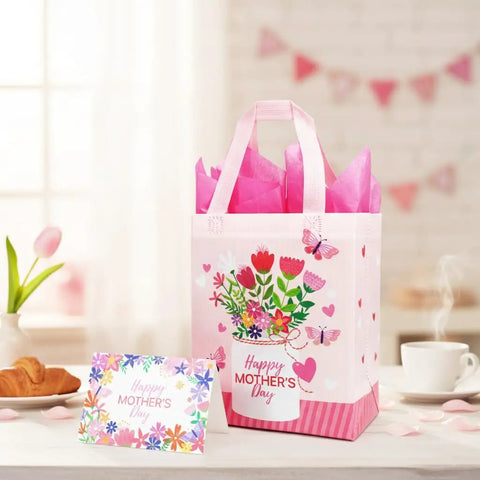 Mother's Day Gift Bags With Tissue Paper Floral Non-Woven Design 10x8x4.7 Inches Pink with card on table.