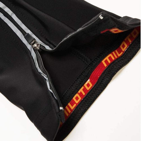 Close-up of black cycling jersey showing zipper and interior lining with logo.