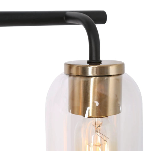 Close-up of Black And Gold Modern Farmhouse Vanity Light with Copper Accent Socket and Clear Glass Shade.