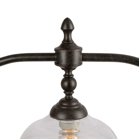Close-up of Farmhouse Chandelier Hanging Light Fixture in rustic black metal with clear glass shade detail.