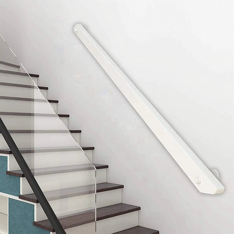 Antislip Round Solid Wood Stair Handrail Wall Mounted Elderly Support Safety Rail For Indoor Hallway And Stairs 20 Feet Long With Durable White Finish installed on a wall beside stairs.