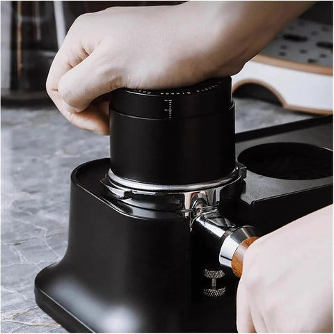 Pro Stainless Steel 58mm Coffee Distributor And Tamper With Slow Rebound Spring in use to compress coffee grounds for espresso.