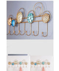 Heavy Duty Wrought Iron Wall Decor With A Dope Partition Rack And Coat Hook This Hand Painted Blue Gold Storage Organizer Sets An Awesome Vibe While Keeping Things Sleek wall hook shelf with circular designs and multiple hooks for coats.