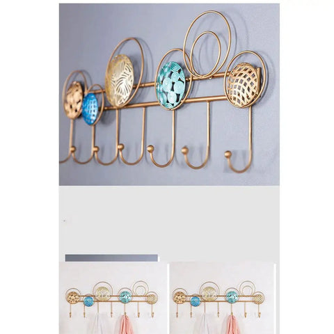 Heavy Duty Wrought Iron Wall Decor With A Dope Partition Rack And Coat Hook This Hand Painted Blue Gold Storage Organizer Sets An Awesome Vibe While Keeping Things Sleek wall hook shelf with circular designs and multiple hooks for coats.