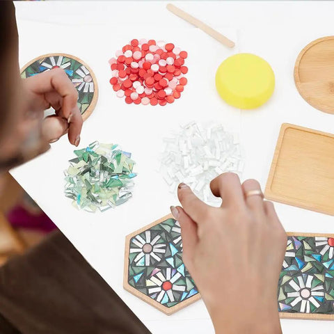 Person assembling Three Styles DIY Mosaic Coaster Kit No Glue Needed for Adults and Beginners with mixed tiles and bamboo bases