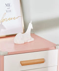 Butter Smooth And Kid Tough Food Grade Silicone Corner Protectors For Baby Proofing Couch And Table Edges securely attached to pink furniture.