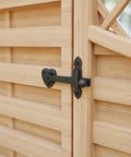 Black Wrought Iron Gate Flip Latch 4 Inch Tall Decorative Antique Heart Style installed on a wooden barn door