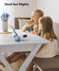 Two children indoors enjoying snacks near Outdoor Indoor Security Cam 1080P 2.4Ghz WiFi Color Night Vision Spotlight IP65.