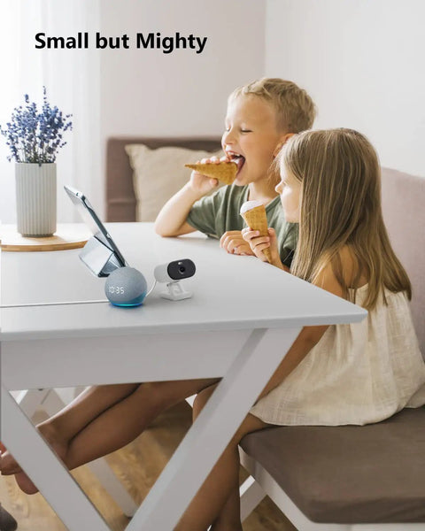 Two children indoors enjoying snacks near Outdoor Indoor Security Cam 1080P 2.4Ghz WiFi Color Night Vision Spotlight IP65.