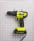 Six Pack Heavy Duty Pegboard Drill Holder Set With Rubber Coated Tool Hooks For Drills And Power Tools Keeps Garage Or Shed Neat And Within Easy Reach installed on pegboard with drill.