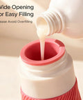 Pouring liquid into the 23 Pack TSA Approved Travel Bottles Set with Leakproof Refillable Silicone Squeezable Bottles in pink.