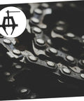 Pro Level Motorcycle Chain Tensioner Tool for Quick Adjustment and Easy Chain Removal next to bike chain detail.