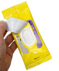 Front view of See Clear Original Lens Cleaning Wipes package; hand lifts a white pre-moistened wipe from a yellow resealable pouch.