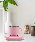 Electric Desk Cup Warmer And Cooler For Coffee Mugs Cans Bottles Precise Hot Cold Temp Control on a desk with a pink cup.