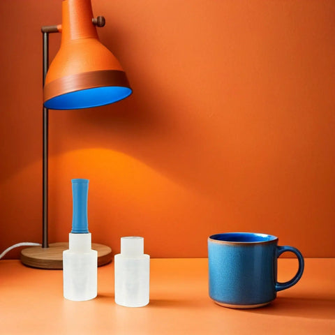 Four Rolls Stretch Film Wrap With Ergonomic Handles for moving on an orange table beside a blue mug and orange lamp