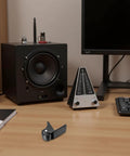 Rigid L Shape Plate Mount Caster on desk near audio equipment, highlighting non-swivel, heavy-duty PVC rubber wheel design for stability.