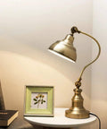 Brass Adjustable Desk Lamp With Rotary Shade Vintage Task Light on white table near book and picture frame.