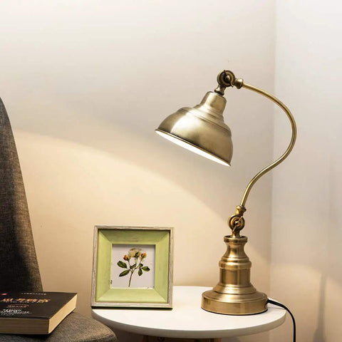 Brass Adjustable Desk Lamp With Rotary Shade Vintage Task Light on white table near book and picture frame.