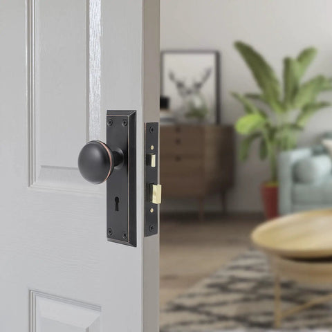 Antique Style Mortise Lock Set for Interior Doors With Privacy Lock installed on white door, oil rubbed bronze finish