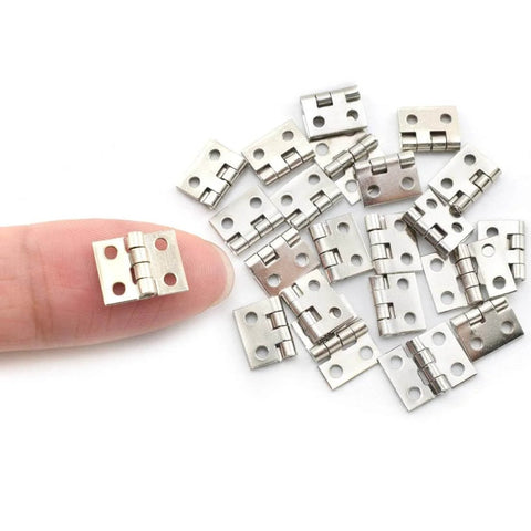Miniature Brass Hinges Set For Jewelry Boxes And Cabinets 24 Pieces 10 By 8 Millimeter silver finish shown next to finger
