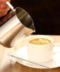 Stainless Steel 304 Milk Frothing Pitcher Cup 12oz 350ml With V Mouth Design for latte art near a cappuccino in a white cup