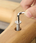 1/4-20 Stainless Socket Head Cap Screws, 1 Inch Long, Full Thread Countersunk Bolts, 304 Stainless Steel With Black Zinc Finish, being installed with hex spanner in wooden surface.