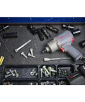 Half Inch Drive Quiet Tech Air Impact Wrench With Up To 1300 Ft Lbs Torque For Pro Grade Assembly And Disassembly Perfect For Suspension Work And Industrial Equipment Repairs on a workbench with tools