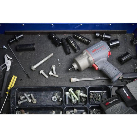Half Inch Drive Quiet Tech Air Impact Wrench With Up To 1300 Ft Lbs Torque For Pro Grade Assembly And Disassembly Perfect For Suspension Work And Industrial Equipment Repairs on a workbench with tools