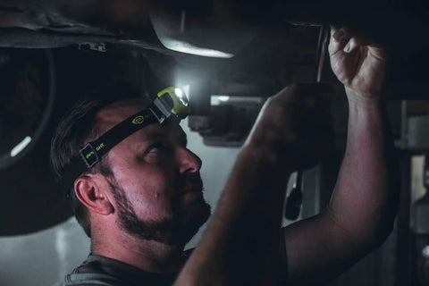 Person using Enduro Pro USB Rechargeable Headlamp With 200 Lumen Output And 2080 Candela All Day Ultra Light LED Spotlight in dark setting